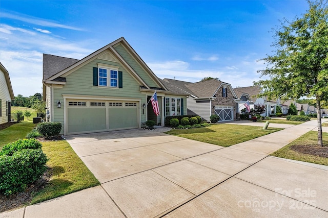 view of front of home with a front lawn, concrete driveway, and a garage