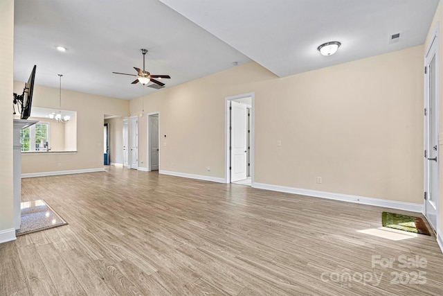 unfurnished living room with visible vents, baseboards, light wood-style flooring, and ceiling fan with notable chandelier