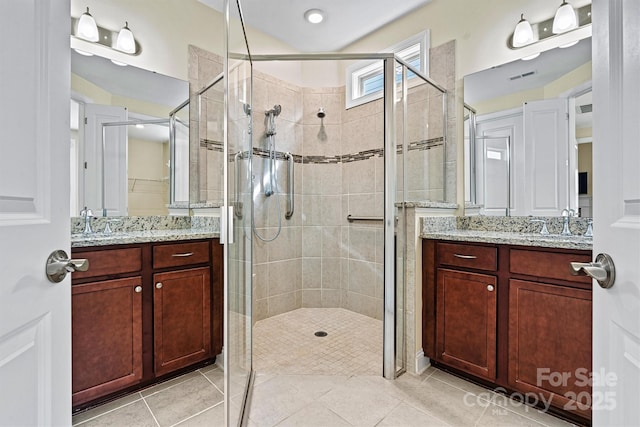 full bath with vanity, tile patterned floors, and a stall shower