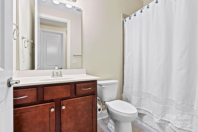 bathroom with tile patterned floors, a shower with shower curtain, toilet, and vanity