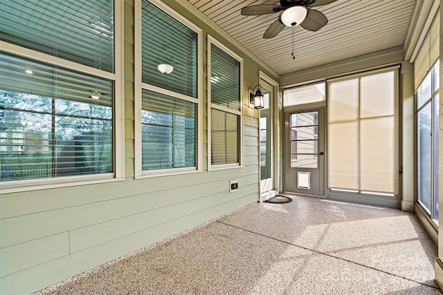 unfurnished sunroom featuring a wealth of natural light and a ceiling fan