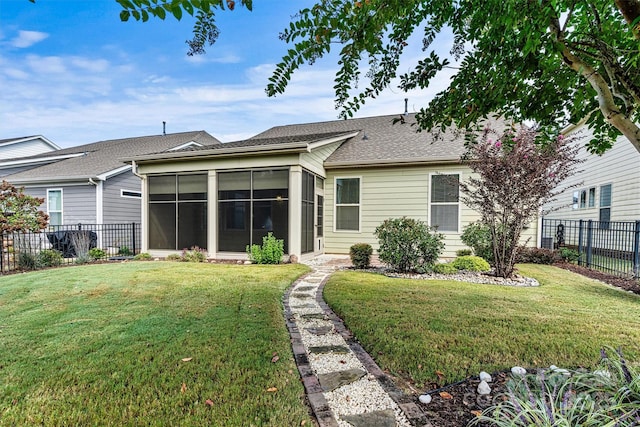 view of front of property with a fenced backyard, roof with shingles, a front lawn, and a sunroom