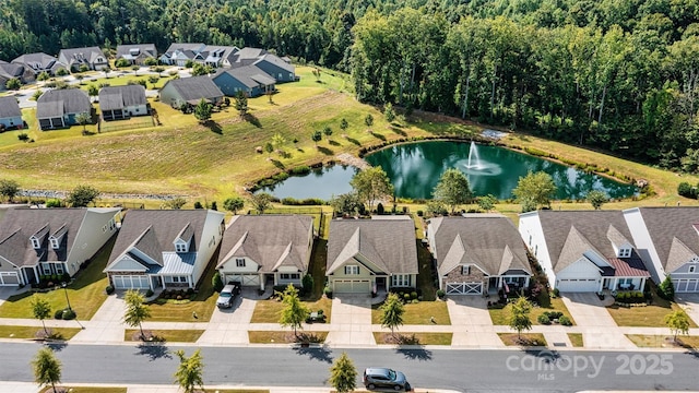 birds eye view of property with a residential view and a water view