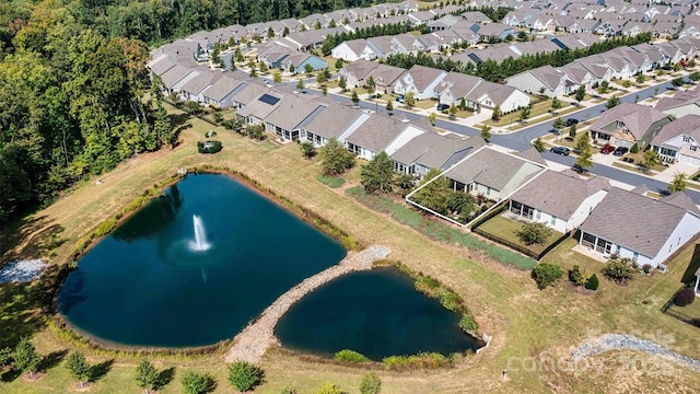 drone / aerial view featuring a residential view and a water view