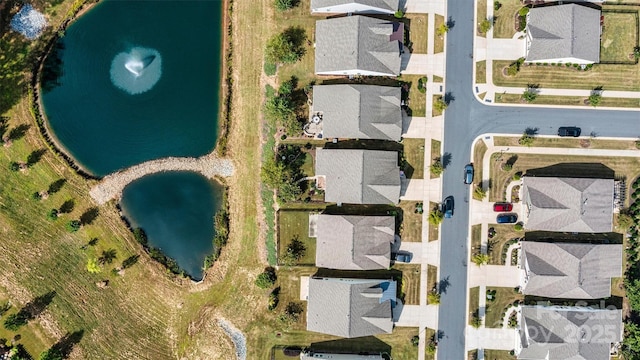 birds eye view of property with a water view and a residential view