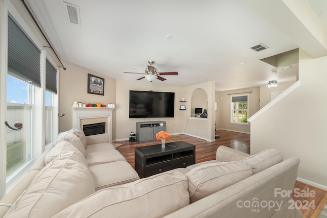 living room featuring hardwood / wood-style floors and ceiling fan