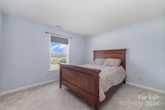 bedroom featuring light carpet