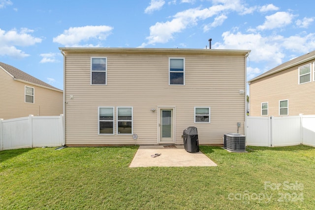 back of house featuring central AC unit, a yard, and a patio