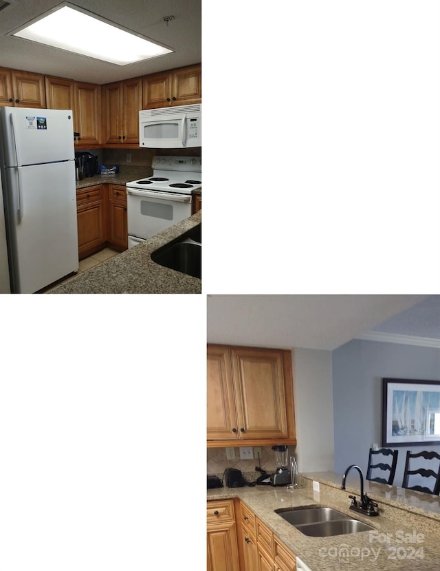 kitchen with white appliances, light stone counters, kitchen peninsula, and sink