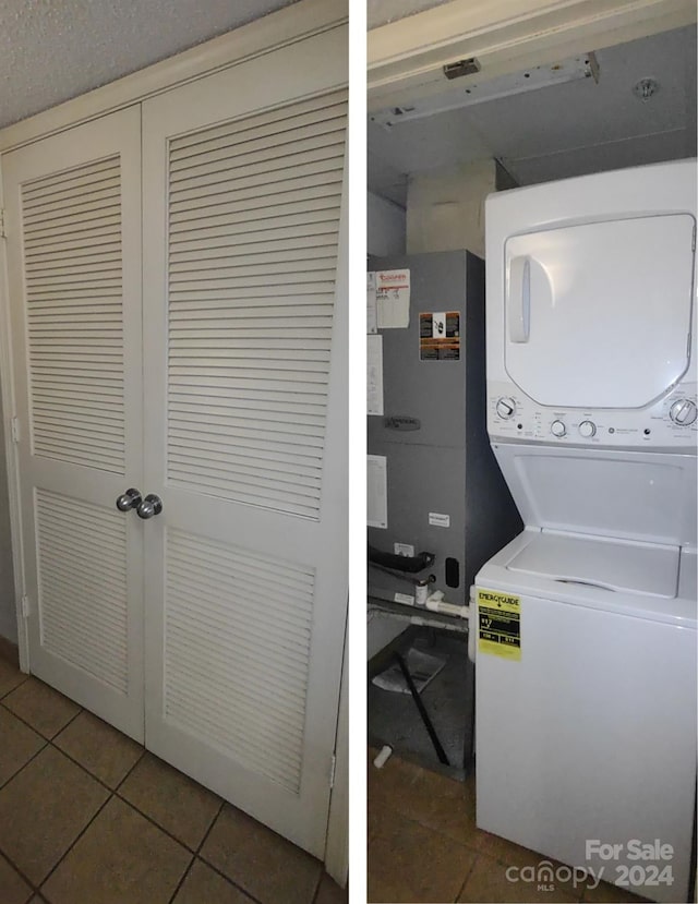 washroom featuring stacked washer and clothes dryer, heating unit, and tile patterned floors