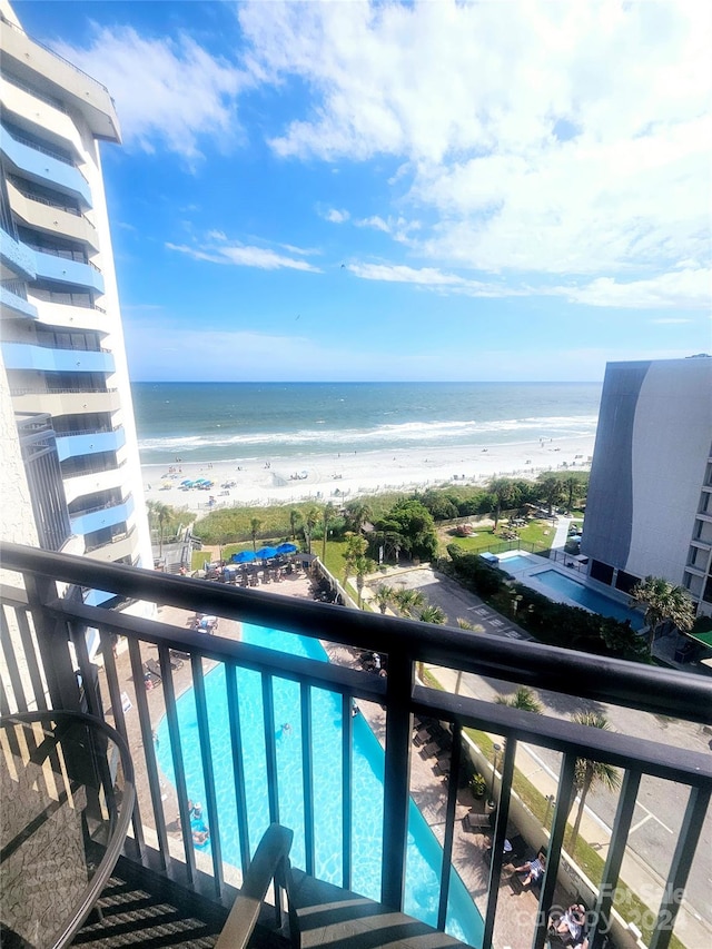 balcony featuring a water view and a view of the beach