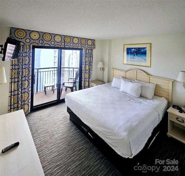 bedroom featuring a textured ceiling and access to outside