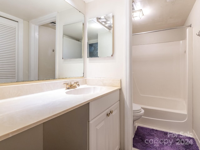 full bathroom featuring bathing tub / shower combination, vanity, and toilet