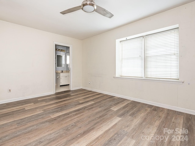 empty room with ceiling fan and hardwood / wood-style floors