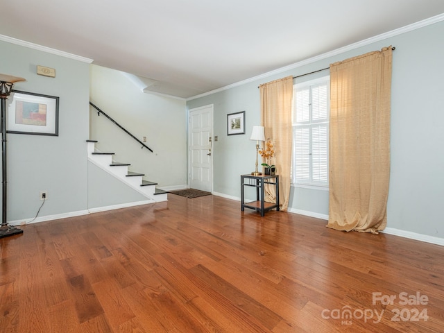 entryway with crown molding and hardwood / wood-style floors