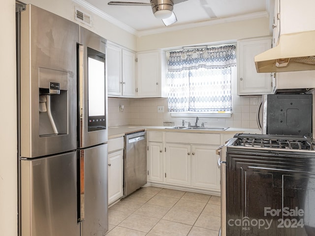 kitchen with white cabinets, backsplash, stainless steel appliances, and extractor fan