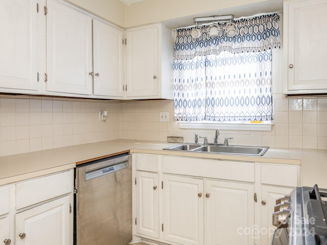 kitchen with stainless steel appliances, white cabinetry, tasteful backsplash, and sink