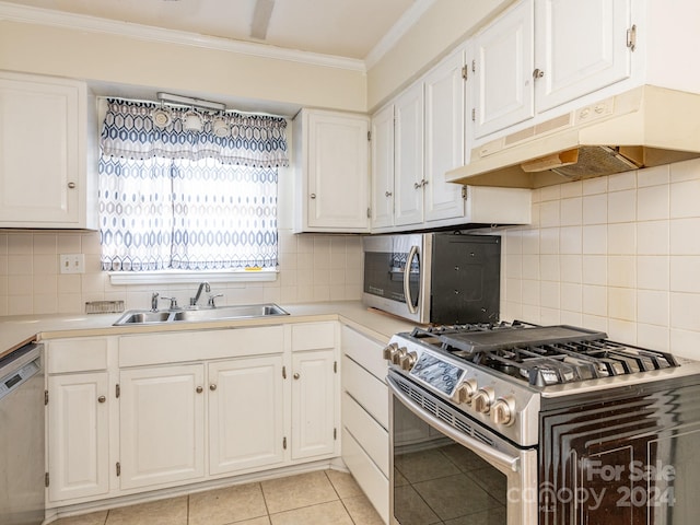 kitchen featuring white cabinetry, sink, light tile patterned floors, and appliances with stainless steel finishes