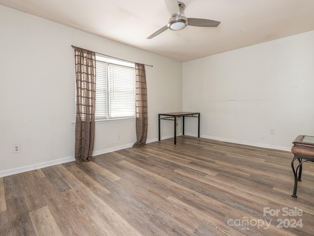 empty room featuring hardwood / wood-style flooring and ceiling fan