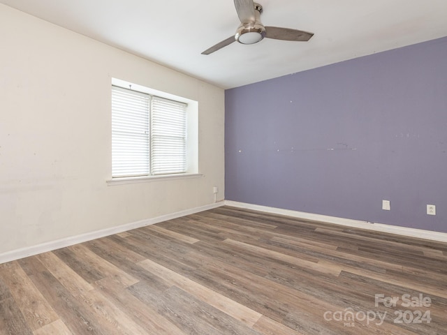 empty room featuring wood-type flooring and ceiling fan