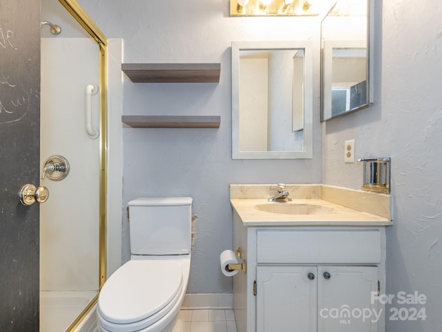 bathroom featuring tile patterned floors, a shower, vanity, and toilet