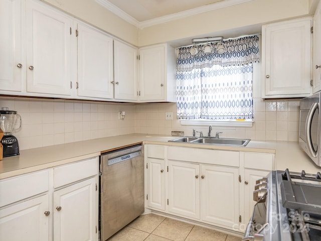 kitchen featuring crown molding, sink, light tile patterned floors, white cabinetry, and stainless steel appliances