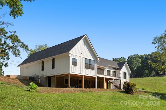 back of property featuring a yard, a deck, and central air condition unit