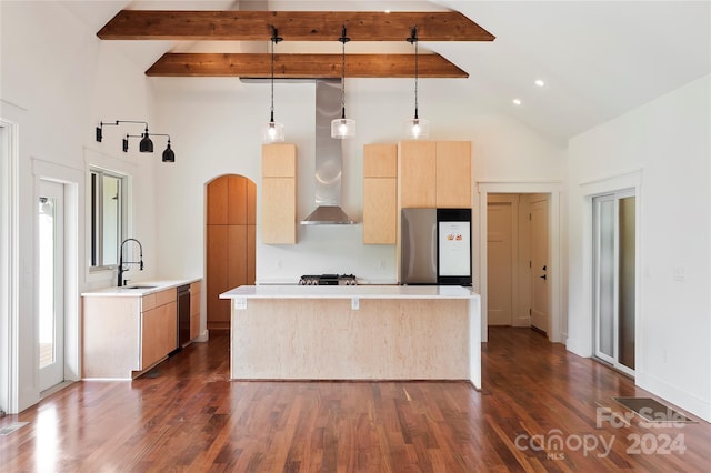 kitchen with appliances with stainless steel finishes, sink, dark hardwood / wood-style floors, wall chimney exhaust hood, and pendant lighting