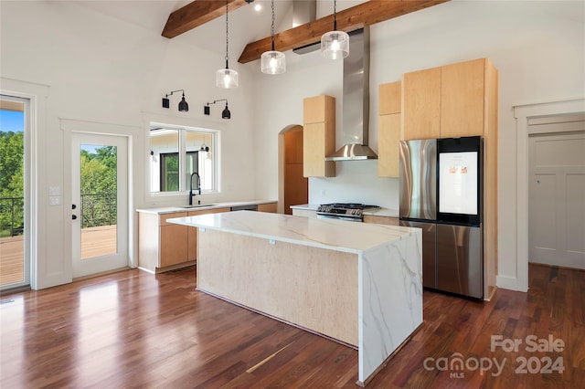 kitchen featuring appliances with stainless steel finishes, sink, wall chimney range hood, dark hardwood / wood-style floors, and a kitchen island