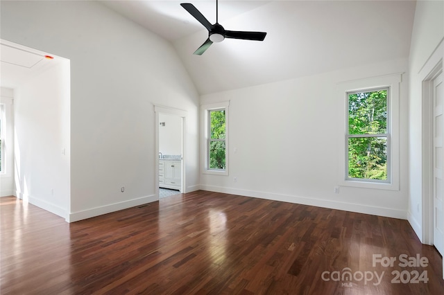 empty room with high vaulted ceiling, ceiling fan, and dark hardwood / wood-style flooring