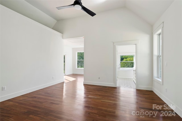 spare room featuring ceiling fan, dark hardwood / wood-style floors, and vaulted ceiling