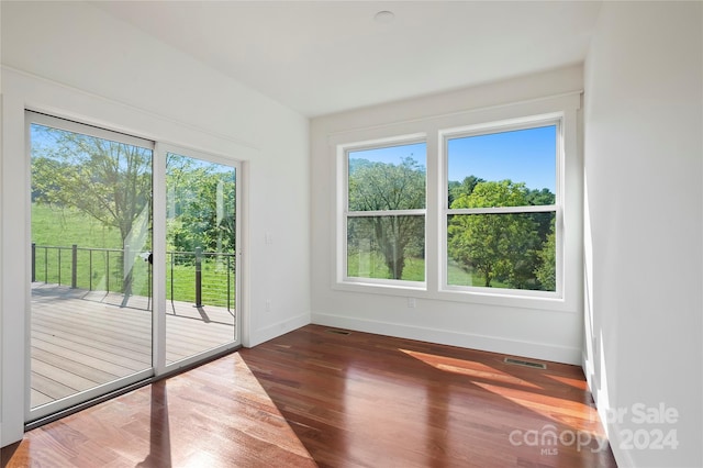 empty room featuring dark hardwood / wood-style flooring