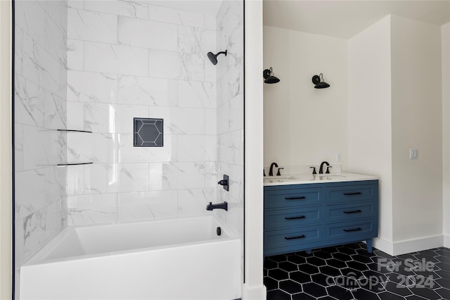 bathroom featuring tile patterned flooring, tiled shower / bath combo, and vanity