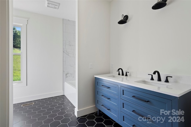 bathroom with vanity, plenty of natural light, tile patterned floors, and tub / shower combination