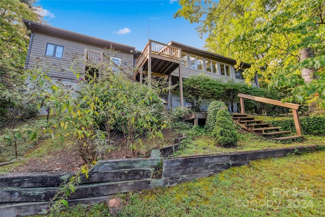 rear view of property featuring a deck