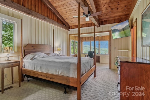 bedroom featuring lofted ceiling with beams, multiple windows, light carpet, and ceiling fan