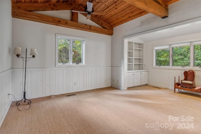 interior space featuring ceiling fan, carpet floors, wooden ceiling, and lofted ceiling with beams