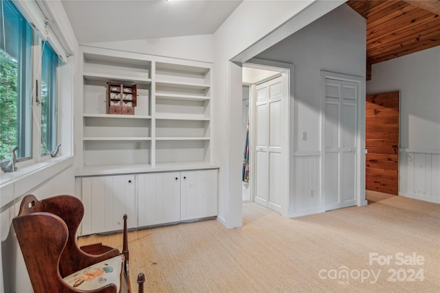 sitting room with light carpet, vaulted ceiling, and wooden ceiling