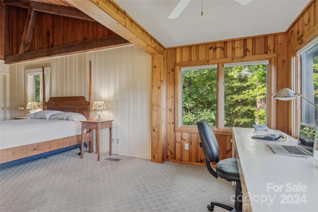 interior space featuring ceiling fan and wooden walls