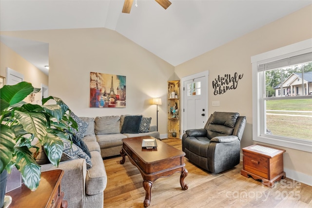 living room featuring ceiling fan, light hardwood / wood-style floors, and vaulted ceiling