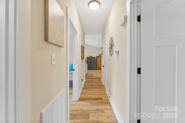 corridor with light wood-type flooring