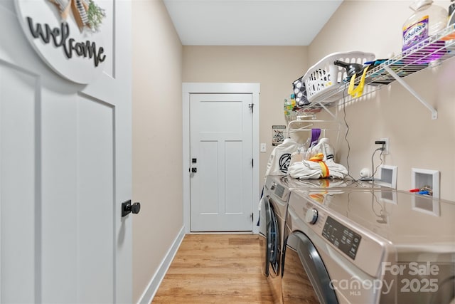 laundry area featuring light wood-type flooring and independent washer and dryer