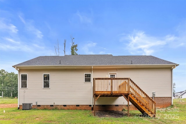 rear view of house with a lawn, a wooden deck, and central AC