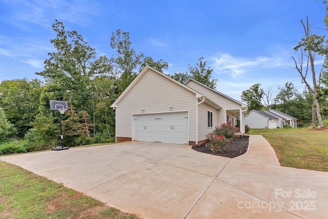 exterior space featuring a garage and a lawn