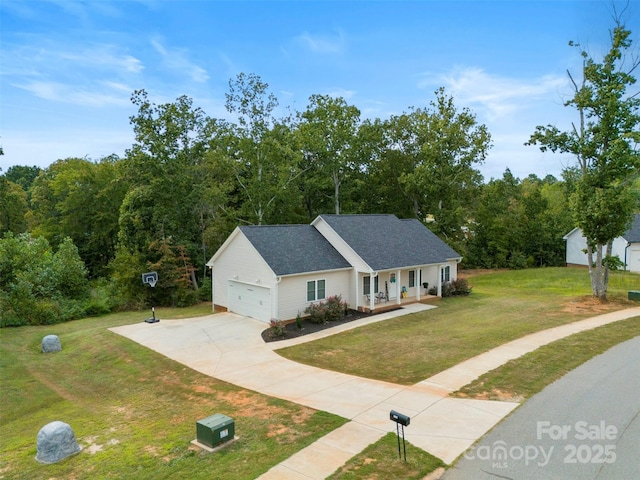 view of front of house featuring covered porch, a garage, and a front lawn