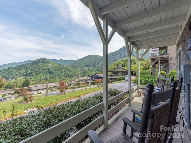 balcony featuring a porch and a mountain view