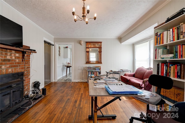 living room featuring ornamental molding, hardwood / wood-style flooring, and a textured ceiling