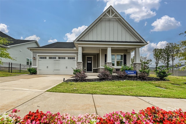 craftsman-style home featuring a garage, a front lawn, and a porch