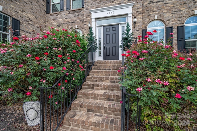 view of exterior entry featuring brick siding