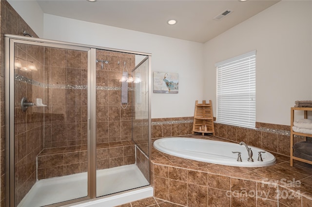 bathroom with visible vents and a stall shower